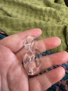 a clear handmade pyrex leaf, held in my hand